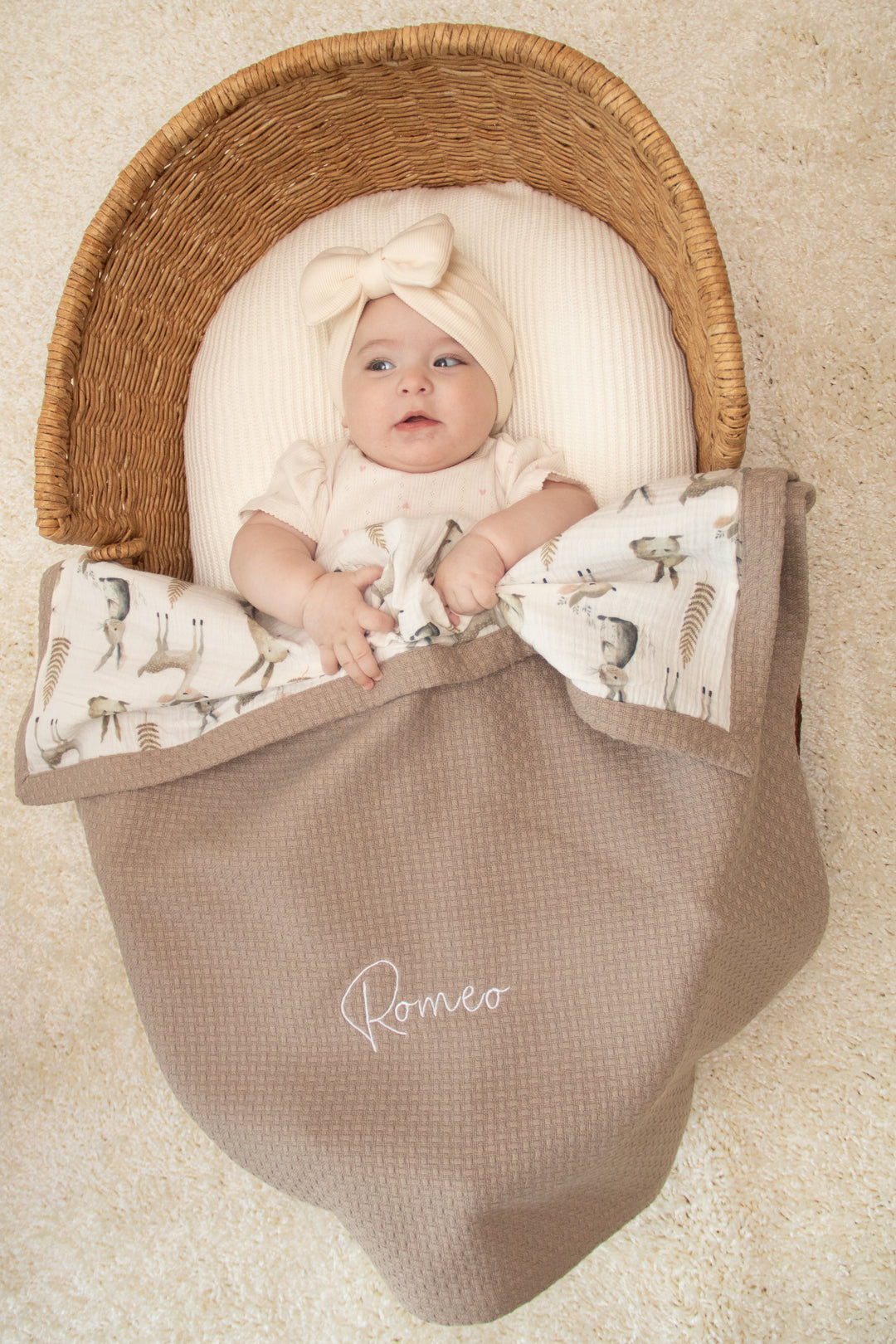 Mouliss baby in basket with personalized taupe waffle baby blanket, woodland muslin, embroidered name