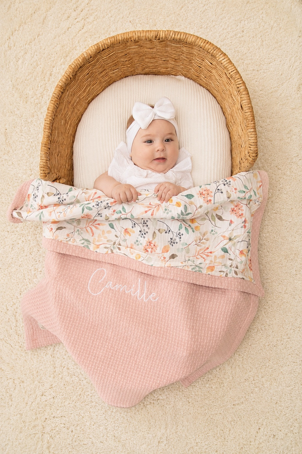 Mouliss baby in basket with personalized pink waffle baby blanket, floral muslin, embroidered name