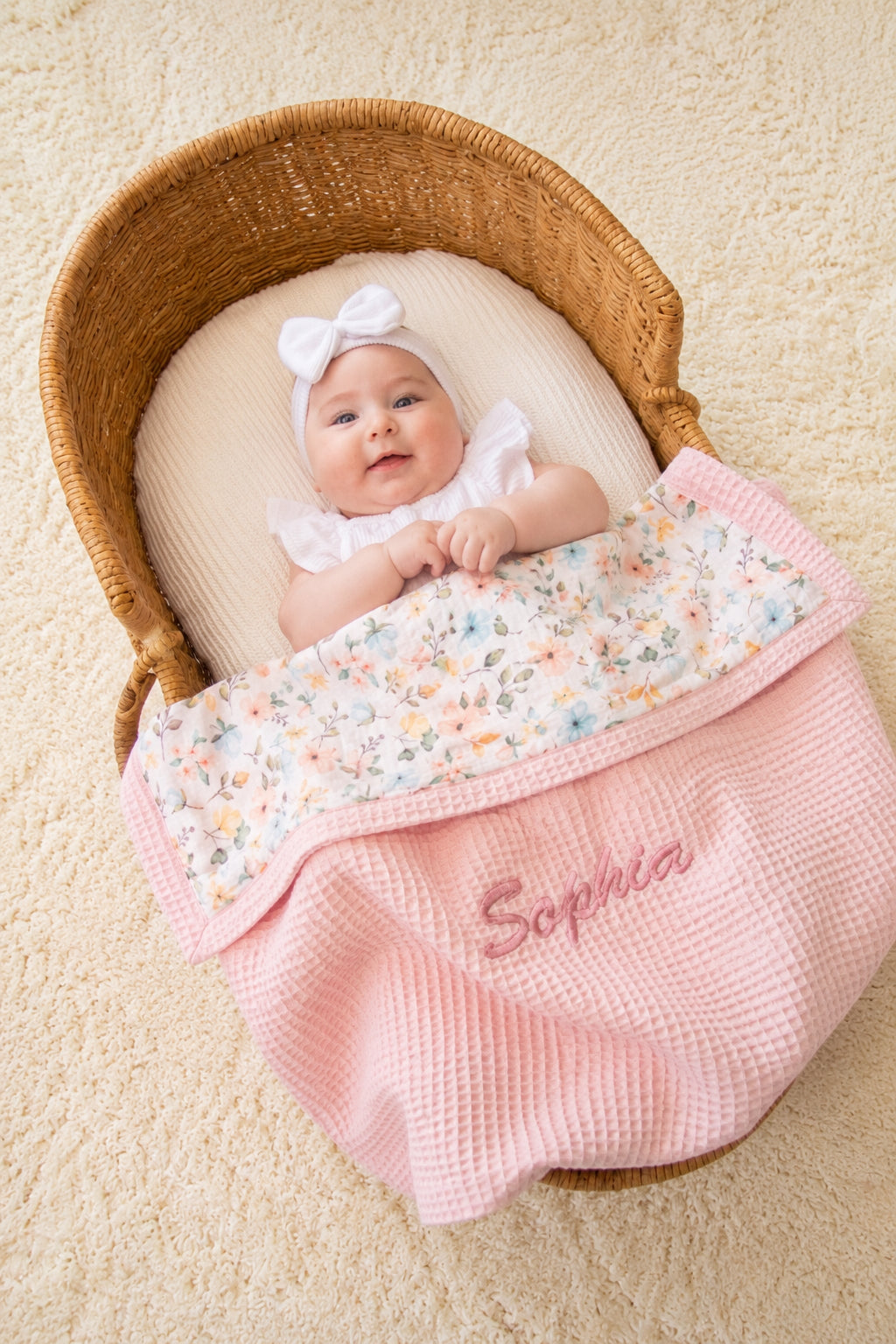 Mouliss baby in basket with personalized pink waffle baby blanket, floral muslin, embroidered name
