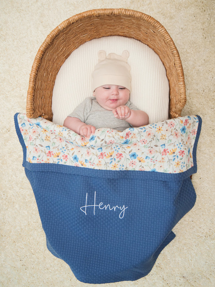 Mouliss embroidered name on personalized navy baby blanket with floral muslin
