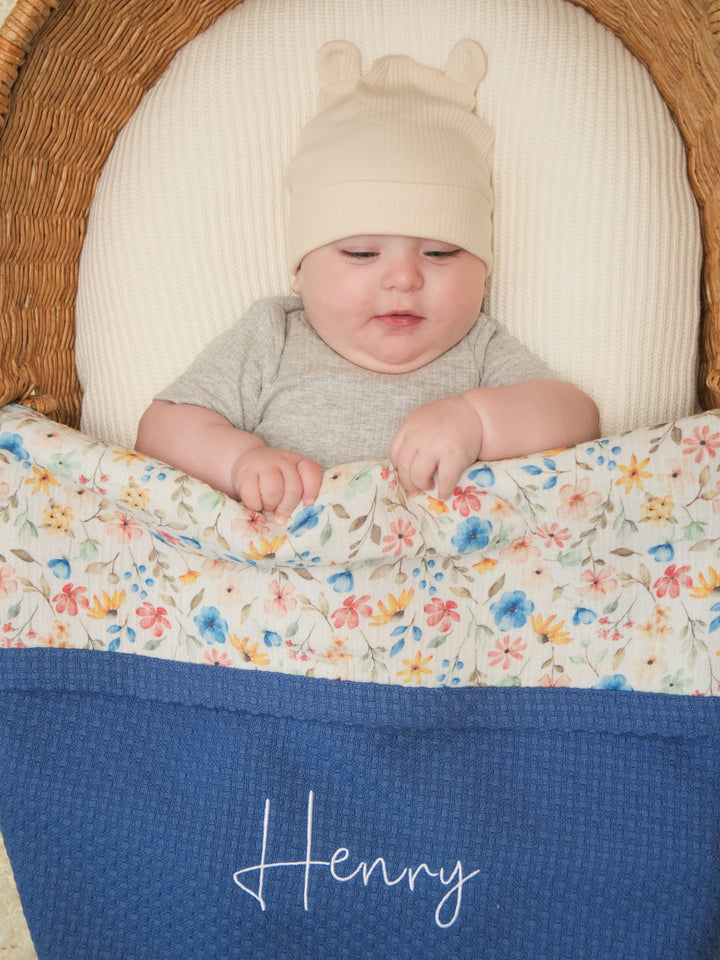 Mouliss personalized navy waffle baby blanket with floral muslin and embroidered name detail