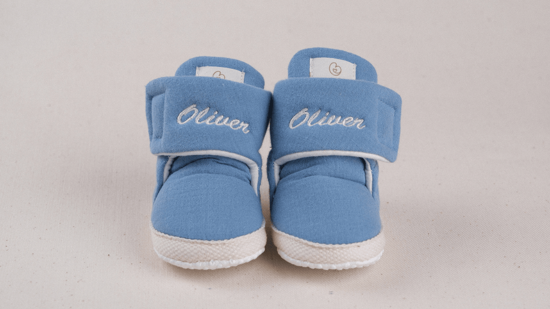 Mouliss Denim Blue muslin personalized baby booties — styling photo 1