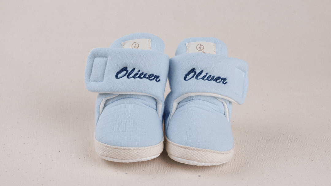 Mouliss Light Blue muslin personalized baby booties — styling photo 1