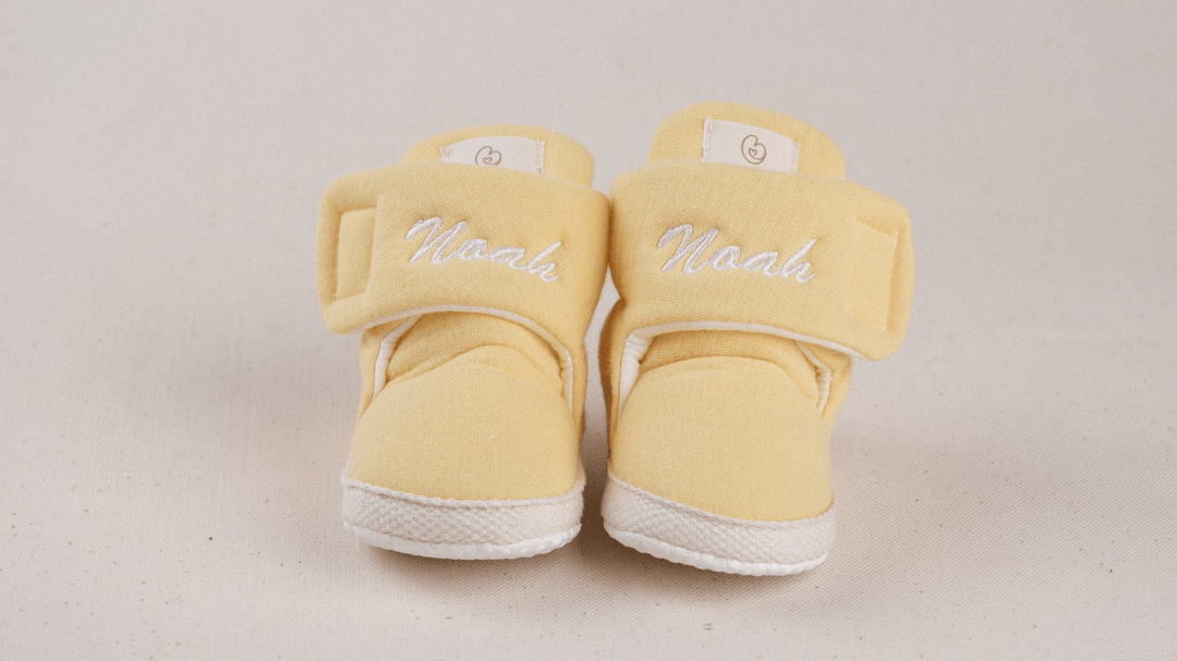 Mouliss Yellow muslin personalized baby booties — styling photo 1