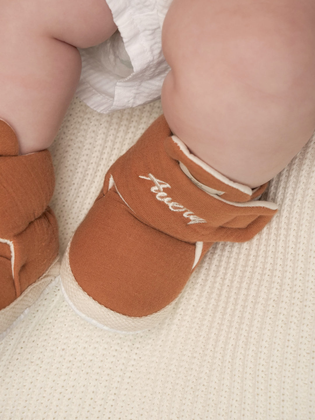 Mouliss personalized terracotta baby booties with embroidered name, top view
