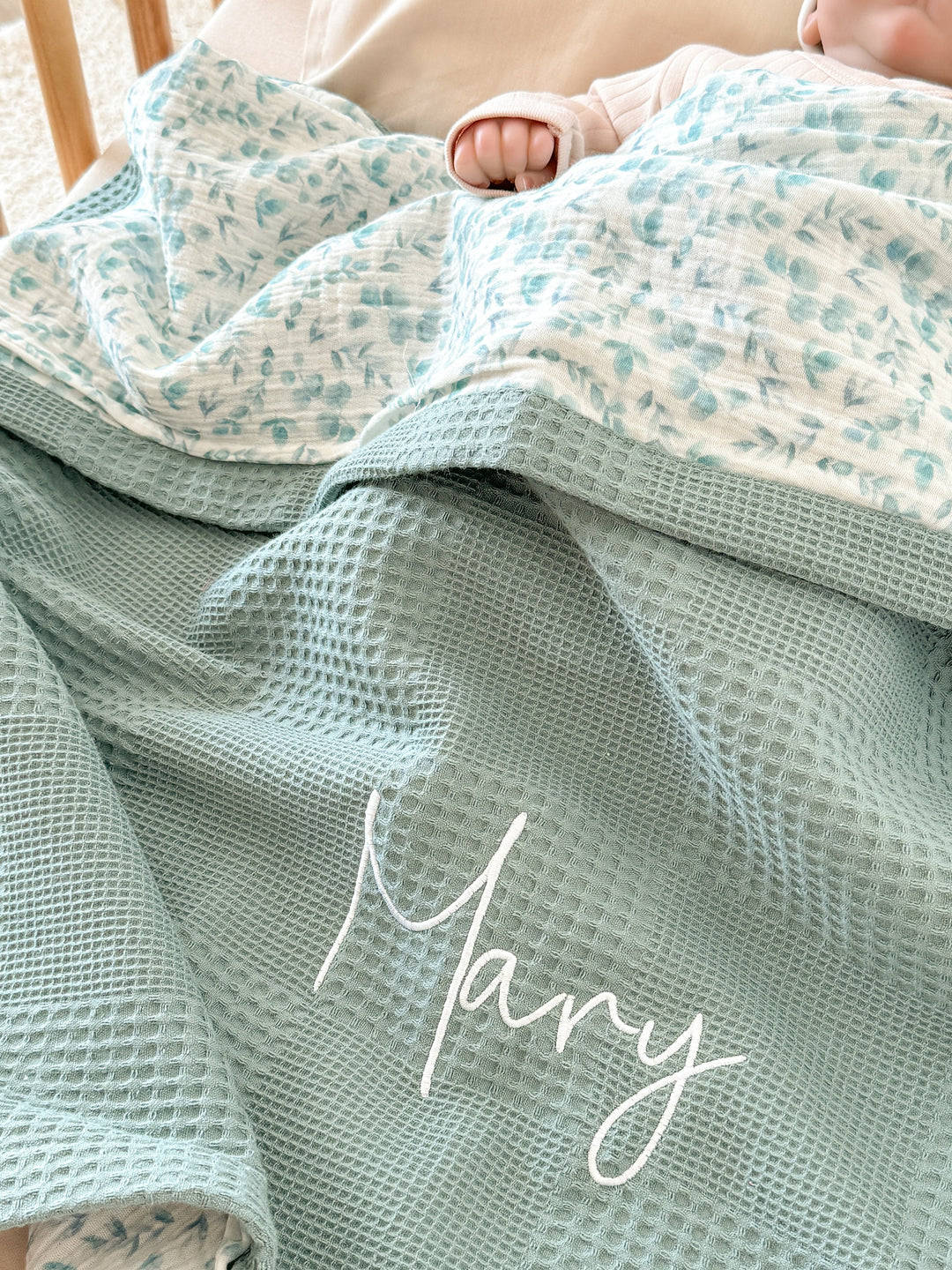Personalized baby blanket by Cotton, featuring sage waffle knit with &