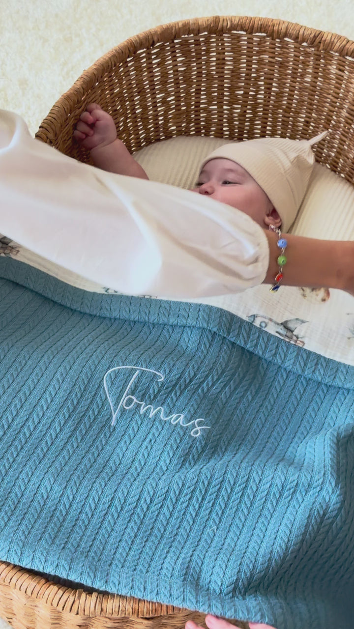 Mouliss personalized blue waffle baby blanket with astronaut muslin, embroidered name, shown in basket