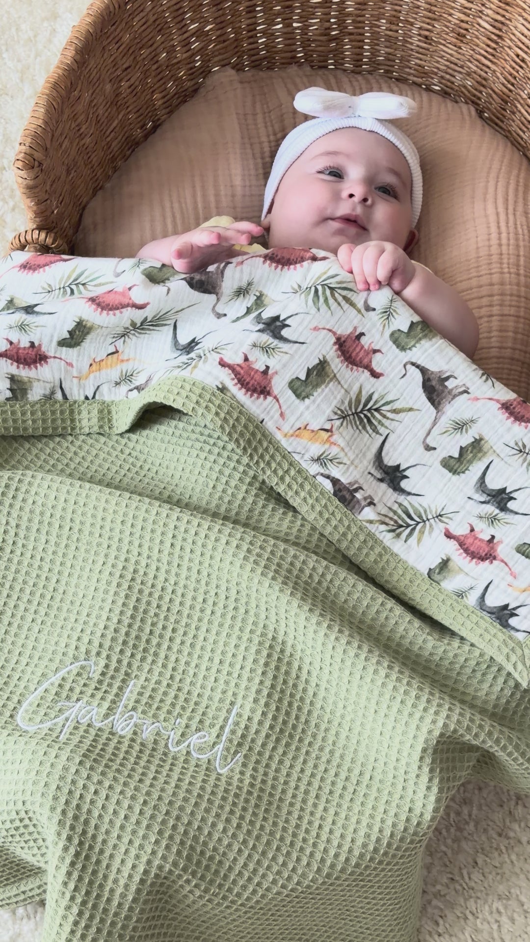 Mouliss personalized sage green waffle baby blanket with dinosaur muslin, embroidered name, shown in basket