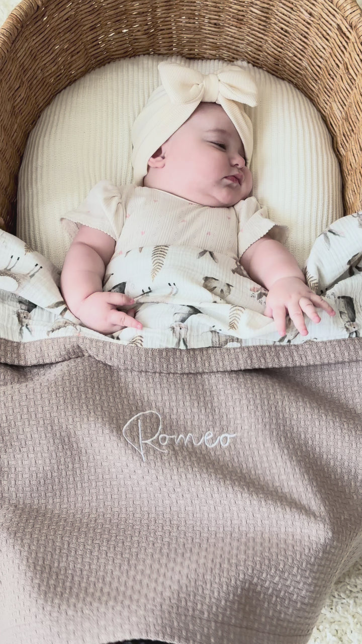 Mouliss personalized taupe waffle baby blanket with woodland muslin, embroidered name, shown in basket