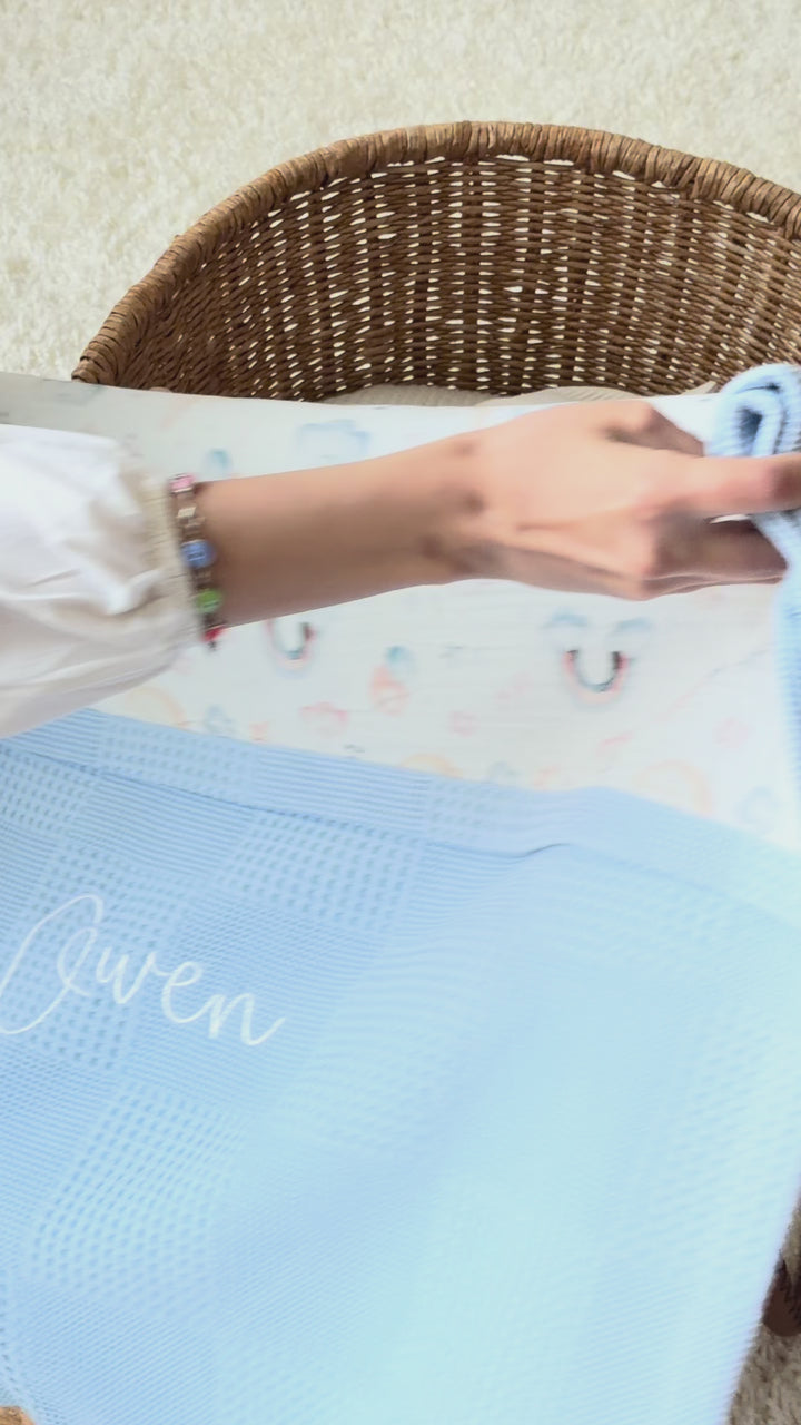 Mouliss personalized blue baby blanket with rainbow muslin, embroidered name, shown in basket