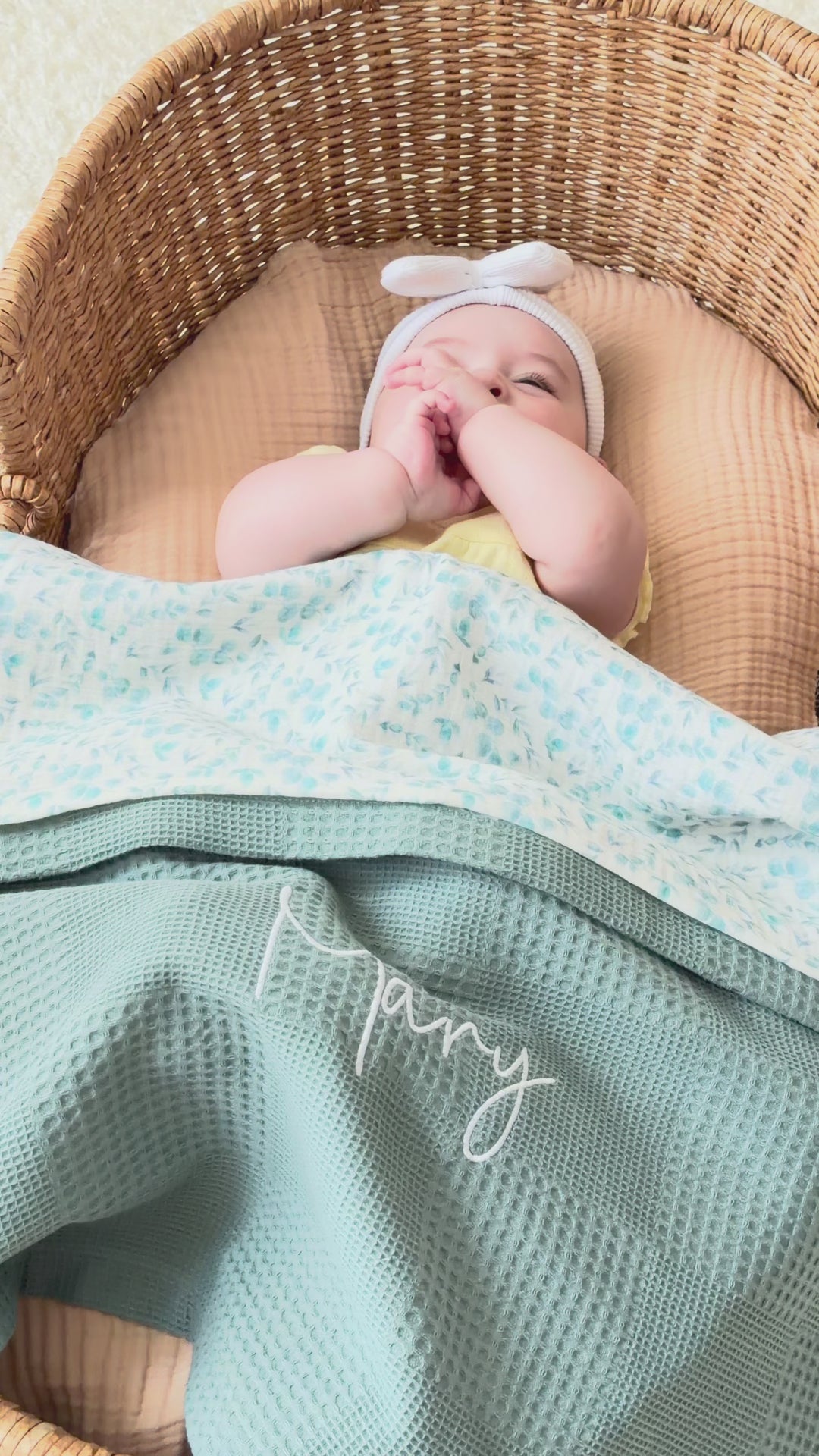 Mouliss personalized sage green baby blanket with floral muslin, embroidered name, shown in basket