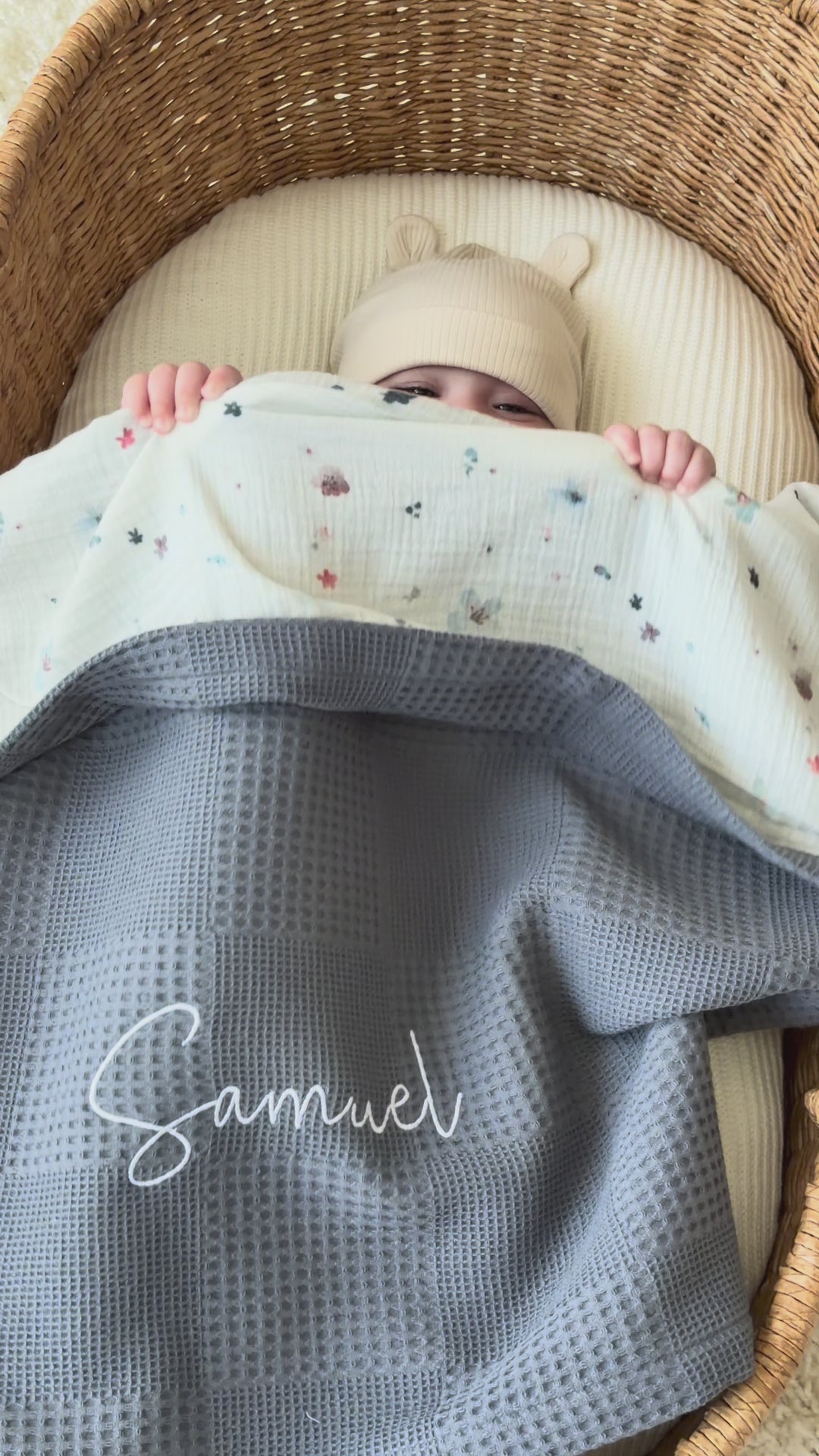 Mouliss personalized grey baby blanket with floral muslin, embroidered name, shown in basket