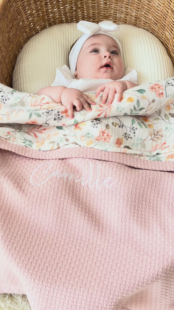 Mouliss personalized pink baby blanket with floral muslin, embroidered name, shown in basket